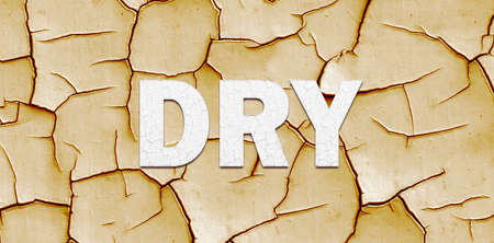 Climate change banner with DRY lettering over dry cracked mud in a concept of the effect of Global Warming on the planetの写真素材