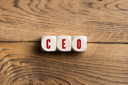 CEO spelled in red on three wooden blocks on wood surfaceの写真素材