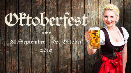 message "Oktoberfest - Sep 21. - Oct 06. 2019" in German beautiful woman in a traditional bavarian dirndl holding a beer in front of wooden backgroundの写真素材