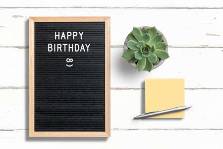 letter board with message happy birthday on wooden background