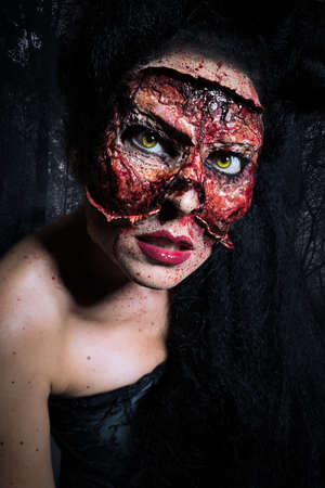 creepy woman with her face missing in front of a forest sceneの写真素材