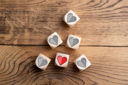 wooden blocks with heart icons on wooden backgroundの写真素材