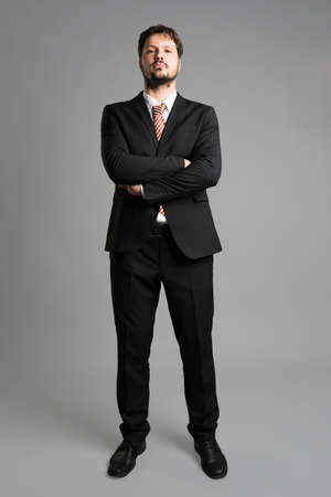 Businessman in front of gray backgroundの写真素材