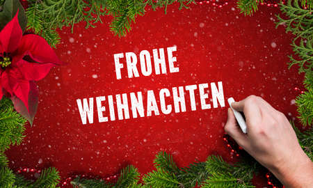 Christmas decoration and German 'Merry Christmas' message on wooden backgroundの写真素材