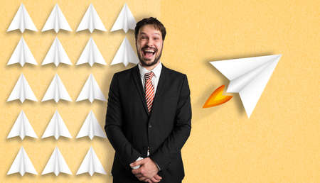 Businessman has an idea symbolized by illustrated airplane with a different approach in front of...
