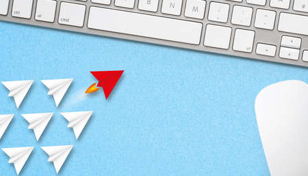 little airplanes and a red one symbolizing leadership on paper background