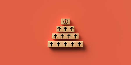 layered wooden blocks on orange background with a compass symbol on top symbolizing to organize a team to a common goal - 3D rendered illustrationの写真素材