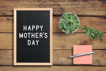 Letter board with text Happy Mother's Day on wooden background