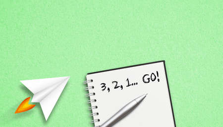 "3, 2, 1 Go" concept written on a notepad lying on paper backgroundの写真素材