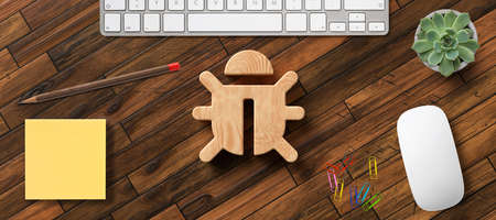 bug icon on wooden desktop with office items viewed from above