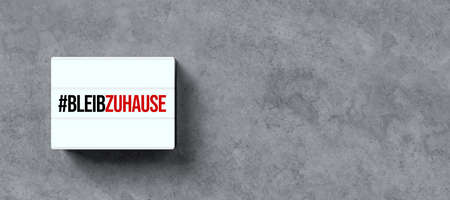 lightbox with text STAY AT HOME in German on concrete background - 3D rendered illustration