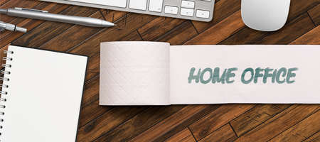 toilet paper with message HOME OFFICE with computer equipment on wooden backgroundの写真素材
