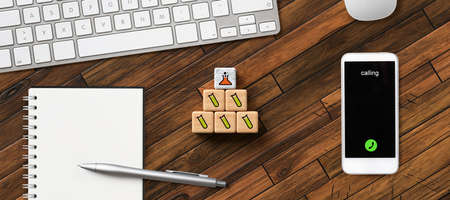 cubes with science symbols and office equipment on wooden background