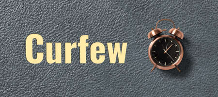 clock with text CURFEW on leather background