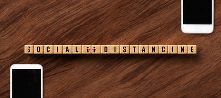 cubes with message SOCIAL DISTANCING on wooden backgroundの写真素材