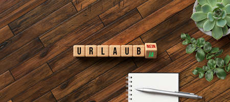 cubes with the German word for VACATION and YES and NO as answers on wooden backgroundの写真素材