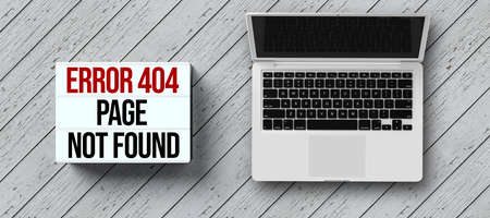 lightbox with message ERROR 404 - PAGE NOT FOUND and laptop on wooden backgroundの写真素材