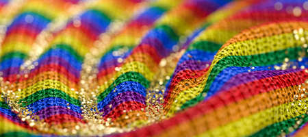 close up of a rainbow-colored wool cloth with golden grains - 3D rendered illustrationの写真素材
