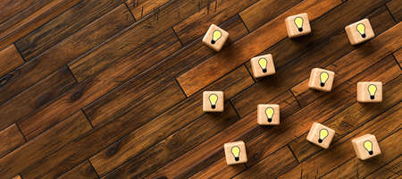cubes with lightbulb symbols on wooden background - 3D rendered illustrationの写真素材
