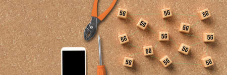 cubes with 5G symbols symbolizing connected network nodes and a smartphone on cork backgroundの写真素材
