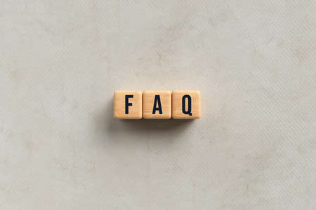 cubes with text FAQ on paper background - 3D rendered illustrationの写真素材