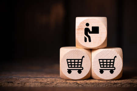 cubes with shopping icons on wooden backgroundの写真素材