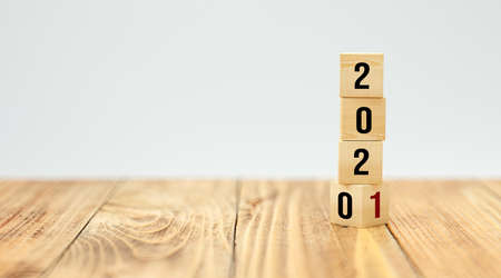 cubes turning from year 2020 to 2021 on white background - 3d illustrationの写真素材