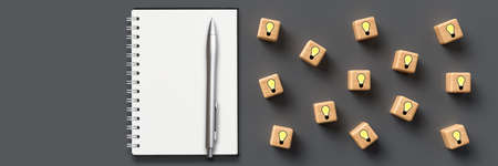 cubes showing idea symbols and notepad on wooden background