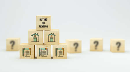 cubes with house symbols and message BUYING OR RENTING on white background - 3d illustration