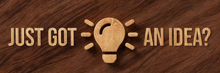 wooden lightbulb symbol and message JUST GOT AN IDEA? on wooden background - 3d illustration