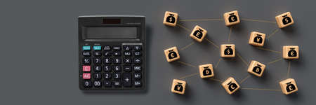 calculator and cubes depicting a money network on grey backgroundの写真素材