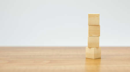 empty wooden cubes for own messages and icons on wooden floor and white background - 3d illustrationの写真素材