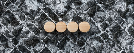 four wooden empty cylinders on snow lava stone pavement - 3d illustration