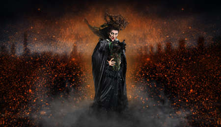 scary witch confuring a spell in front of Halloween background