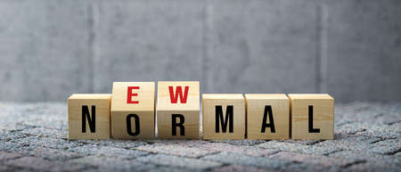 cubes with message NEW NORMAL on concrete background - 3d illustrationの写真素材