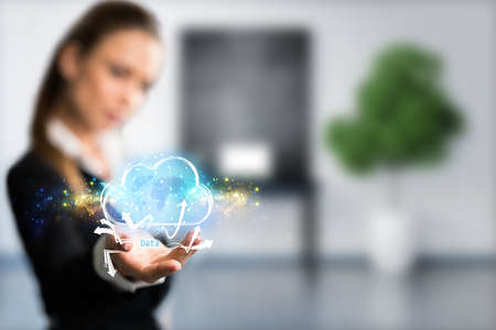 businesswoman interacting with a virtual cloud in front of an office background