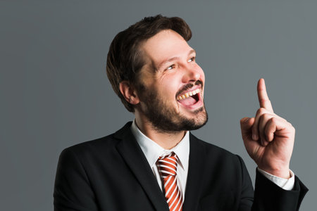 businessman has an idea in front of grey backgroundの写真素材