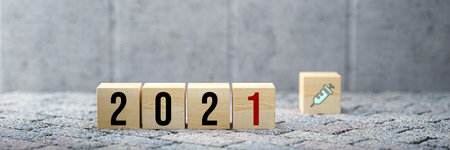 cubes with number 2021 and vaccination symbol on concrete background - 3d illustrationの写真素材