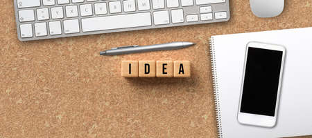 wooden cubes with message IDEA and office items on cork backgroundの写真素材