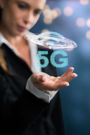 businesswoman with message 5G on abstract blue background