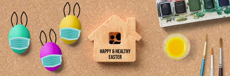 wooden house symbol with message HAPPY & HEALTHY EASTER and easter eggs covered by face mask icons...