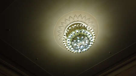 The working chandelier on a room ceilingの写真素材