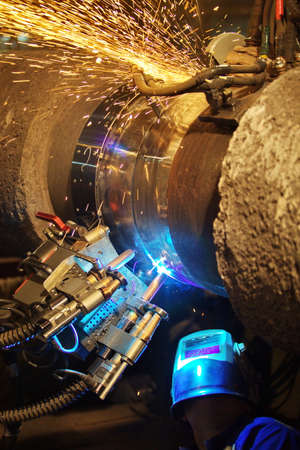 Welding of the pipeline. Process of creation of welding connection by the special mobile machine.の写真素材