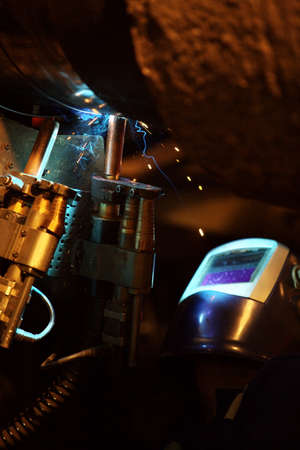 Welding of the pipeline. Process of creation of welding connection by the special mobile machine.