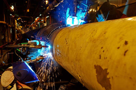 Welding of the pipeline. Process of creation of welding connection by the special mobile machine.の写真素材