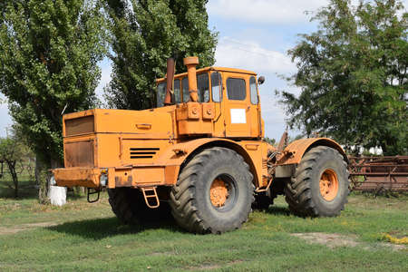 Big yellow tractor. Old Soviet agricultural machinery.