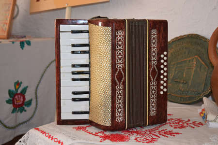 Old dusty accordion. Musical instruments of the Russian village.