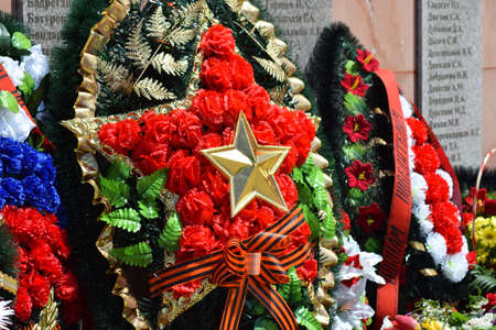VILLAGE POLTAVA. 9 May, 2015: The laid flowers to a monument in honor of a Victory Day on May 9. Patriotic traditions.のeditorial素材