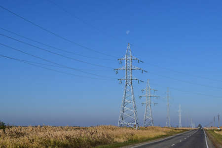 Support of electricity cables along the road. Country road.の写真素材