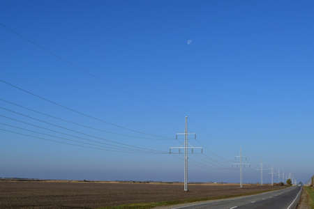 Support of electricity cables along the road. Country road.の写真素材